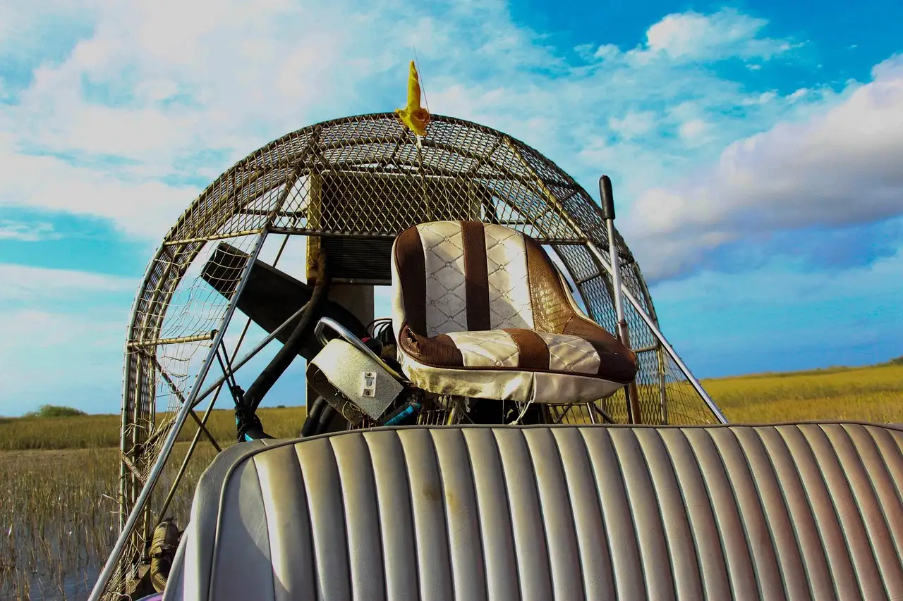 The seats and fan cage of an airboat parked in Everglades sawgrass