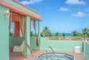 A pastel Art Deco terrace with a hot tub and palm trees