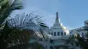 The stepped tower of an Art Deco hotel behind palm fronds