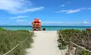 A sandy path through the dunes to a lifeguard tower on Miami Beach