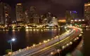 The Brickell skyline and causeway lit up at night