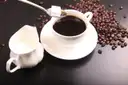 Cups of coffee with roasted beans