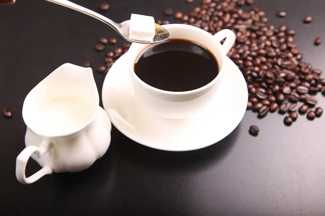Cups of coffee with roasted beans