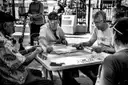 Men playing dominoes at a table in Domino Park, Little Havana
