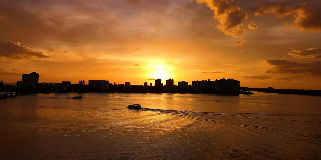 A boat crossing a Florida bay at sunset