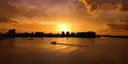 A boat crossing a Florida bay at sunset