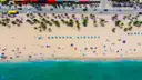 Fort Lauderdale beach from straight above: palms, umbrellas and the shoreline