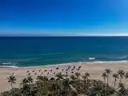 Fort Lauderdale beach with palms, umbrellas and blue sea, seen from above