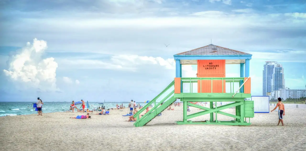 Colourful lifeguard stand on South Beach with swimmers on the sand