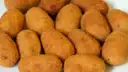 A plate of golden fried croquetas