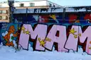A long wall of colourful spray-painted graffiti letters