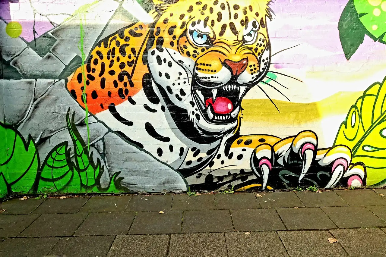 A street-art mural of a jaguar among leaves