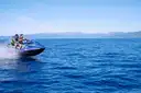A jet ski speeding across deep blue water