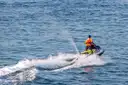 A jet ski rider on choppy blue water