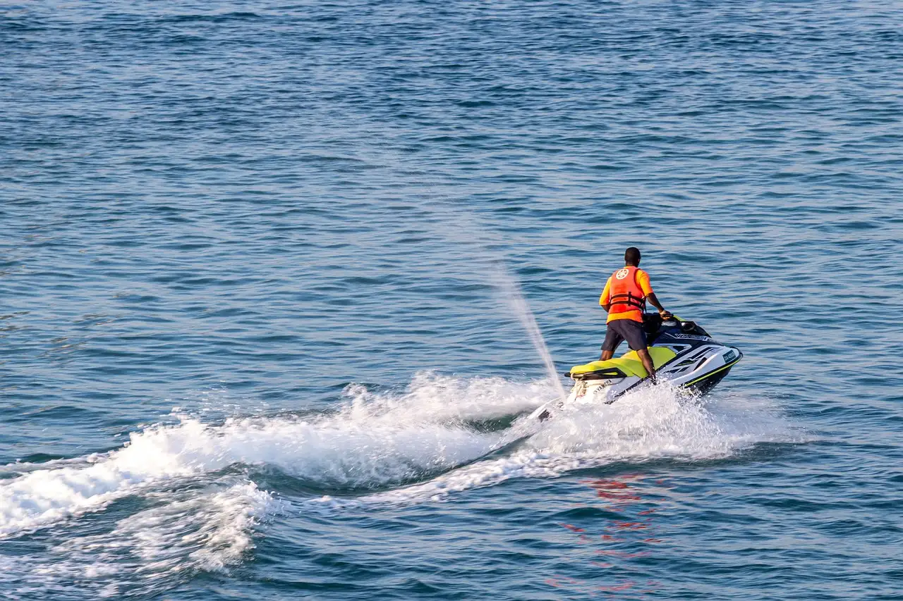 A jet ski rider on choppy blue water