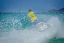 A jet ski carving a turn in turquoise water