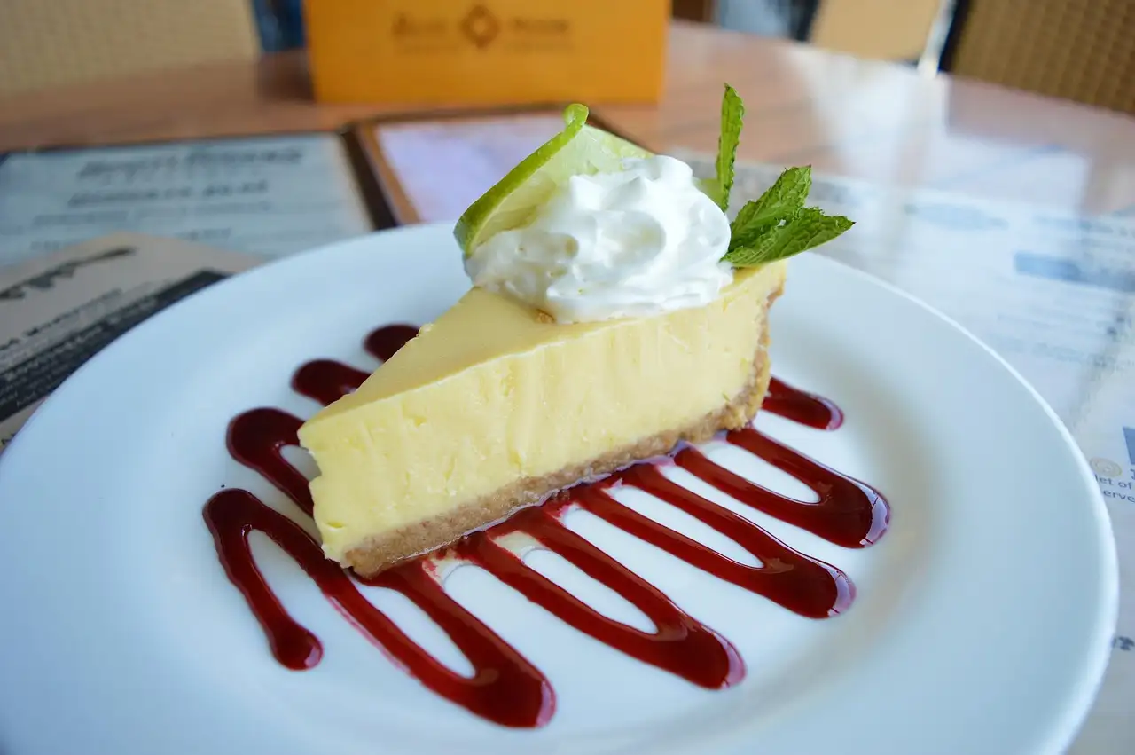 A slice of key lime pie with cream