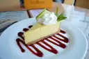A slice of key lime pie with cream