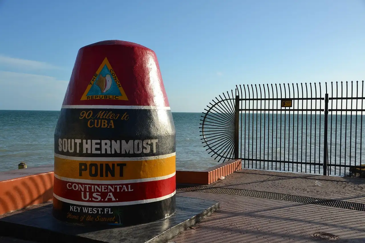 The Southernmost Point buoy in Key West, with the sea behind it