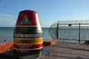 The Southernmost Point buoy in Key West, with the sea behind it