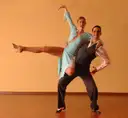 A dancer performing a high leg lift in a show