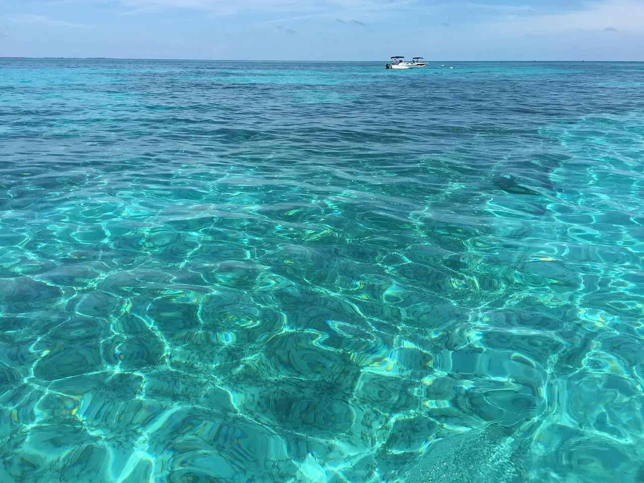 Clear turquoise water over the reef at Looe Key in the Florida Keys, with a boat beyond