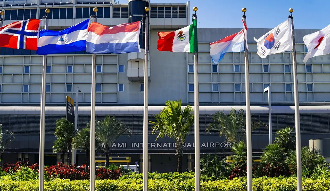 Entrance of Miami International Airport with a row of national flags