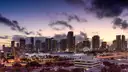 Downtown Miami skyline at dusk with the city lights coming on