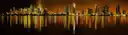 Miami skyline at night reflected in the water of Biscayne Bay