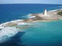 Lighthouse on the rocky shore of Paradise Island, Nassau, with turquoise water
