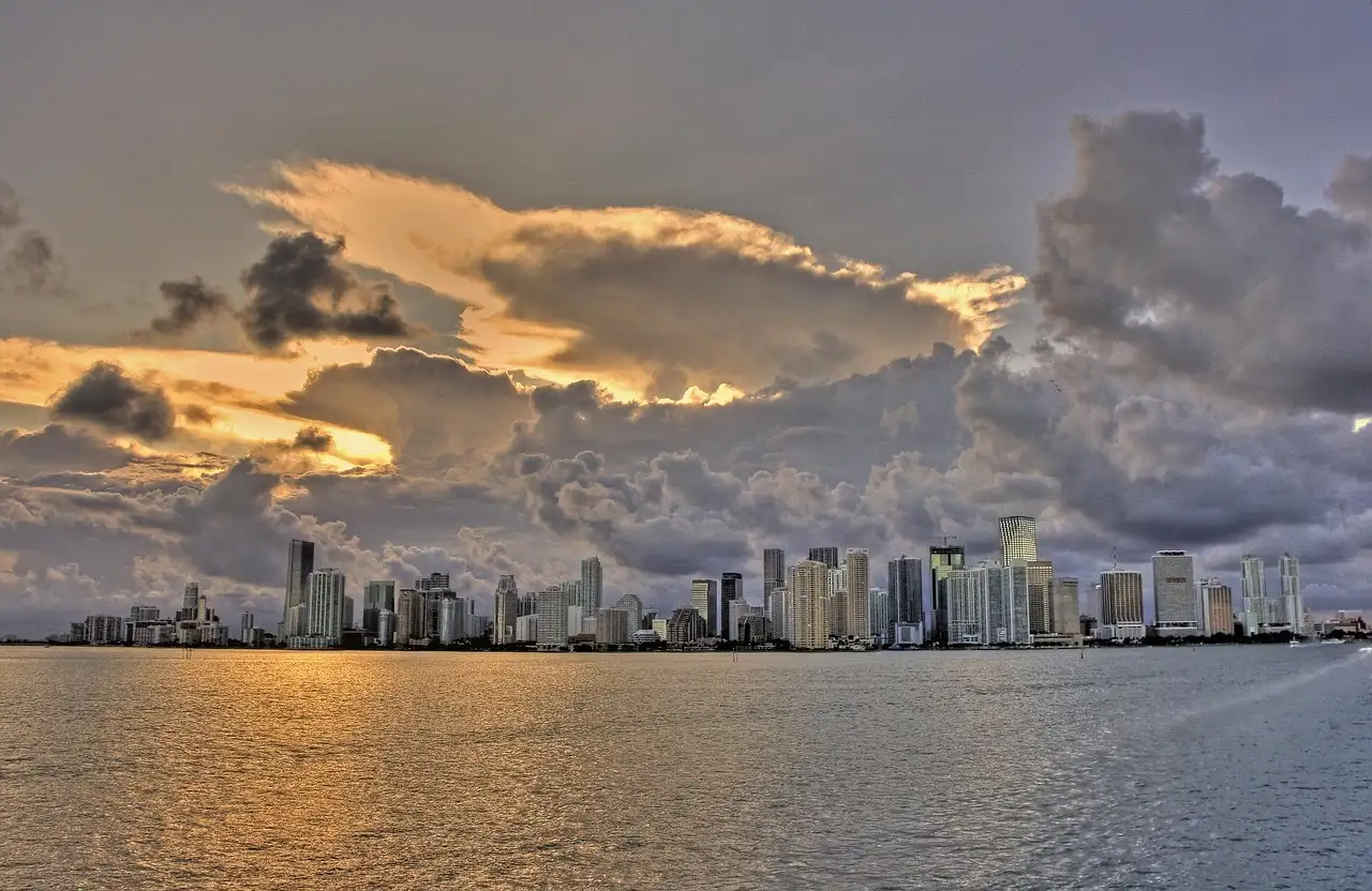 The Miami skyline seen across the bay under dramatic clouds