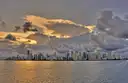 The Miami skyline seen across the bay under dramatic clouds