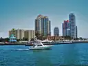A motor yacht cruising past the Miami Beach towers
