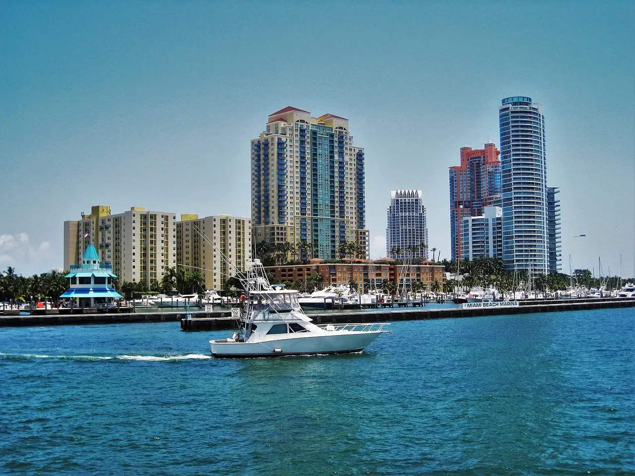 A motor yacht cruising past the Miami Beach towers