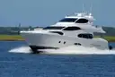 A white motor yacht speeding across the water