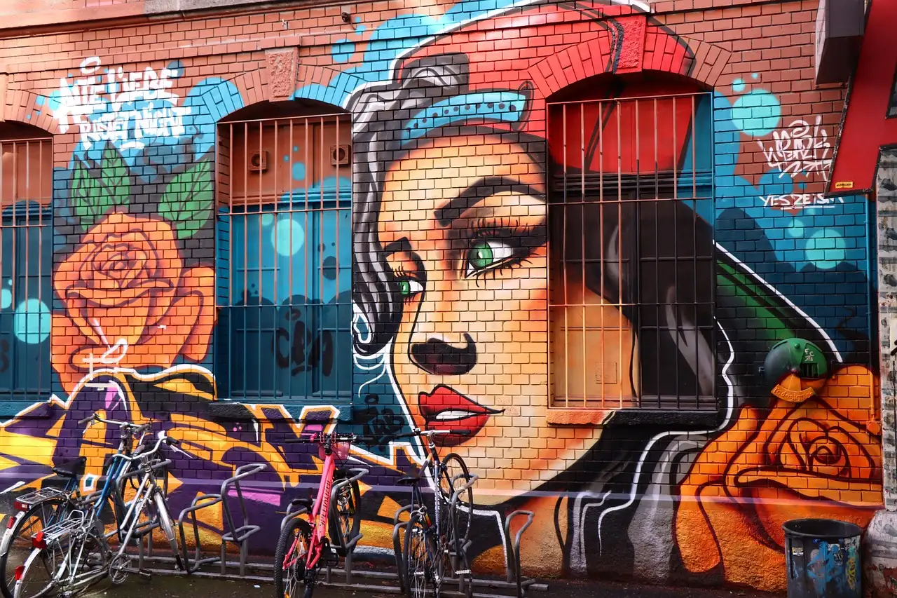 A large painted mural of a woman's face on a building