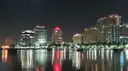 City lights reflecting on the water at night, Miami nightlife skyline