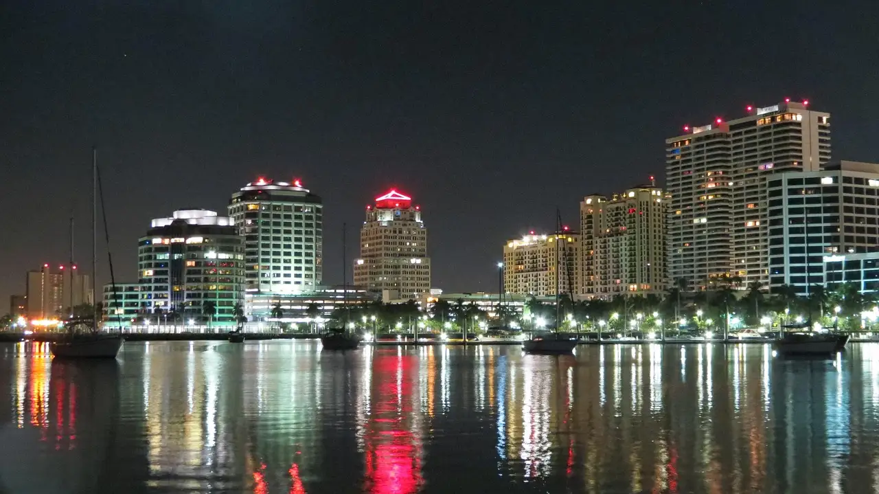 City lights reflecting on the water at night, Miami nightlife skyline