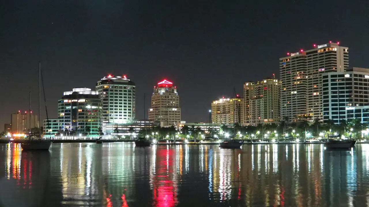 City lights reflecting on the water at night, Miami nightlife skyline