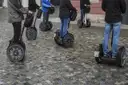 A group of Segways lined up on a stone street