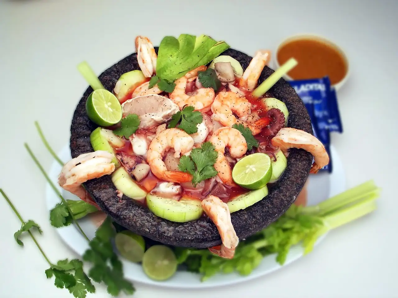 Shrimp ceviche with avocado and lime in a stone bowl
