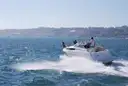 A speedboat cutting through blue water