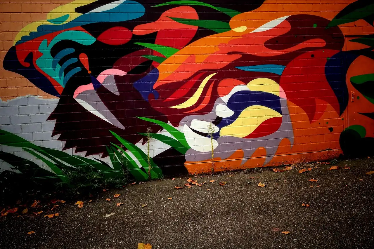 A bold street-art mural in red, orange and black