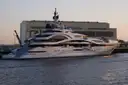 A superyacht moored in a harbour in evening light
