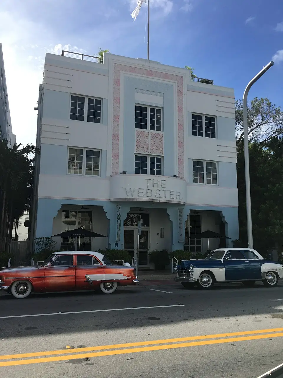 Art Deco building on a South Beach street with classic cars parked outside