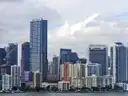 Downtown Miami high-rises seen from the water under a cloudy sky