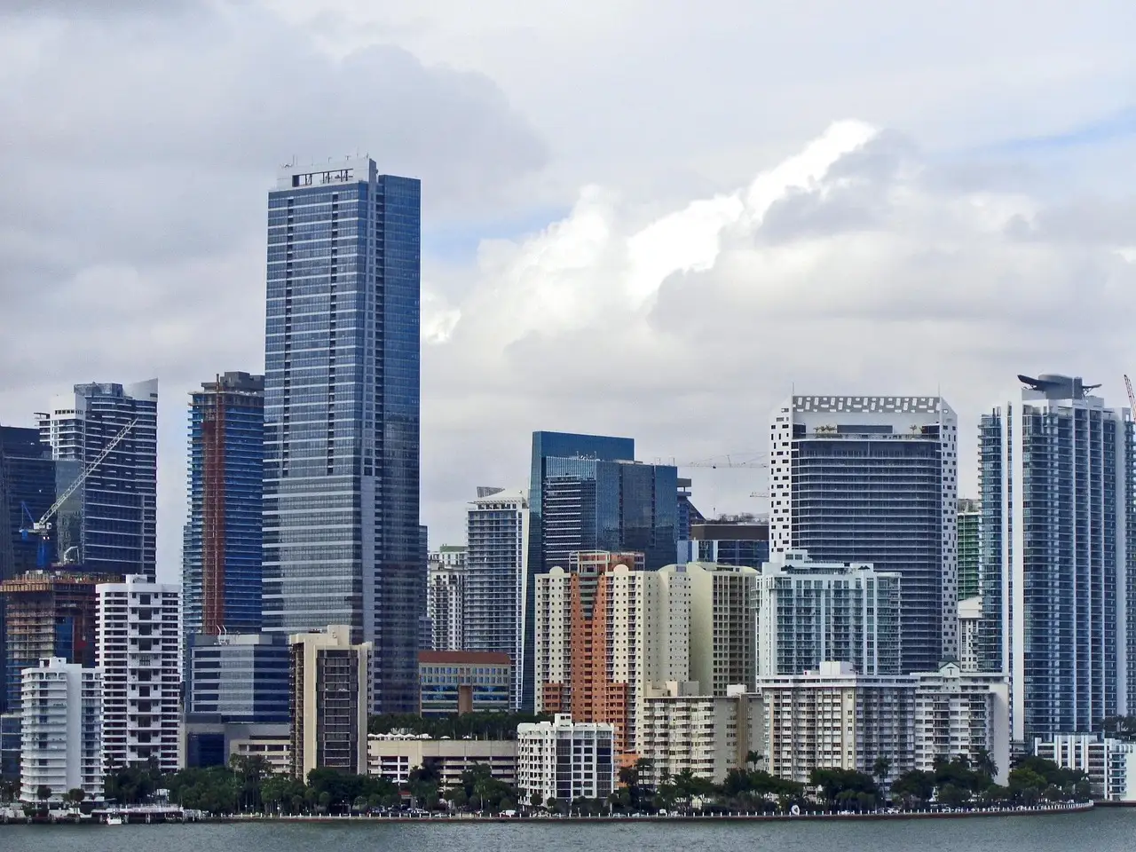 Downtown Miami high-rises seen from the water under a cloudy sky
