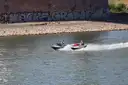 Two jet skis riding side by side