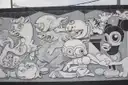A black-and-white cartoon mural on a street wall in Wynwood