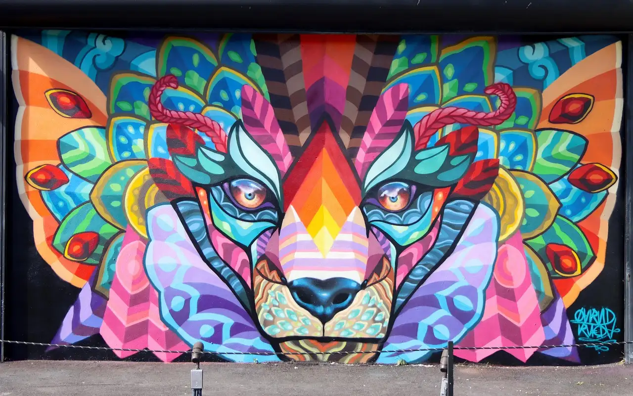 A large, colourful street-art mural of an animal face in Miami